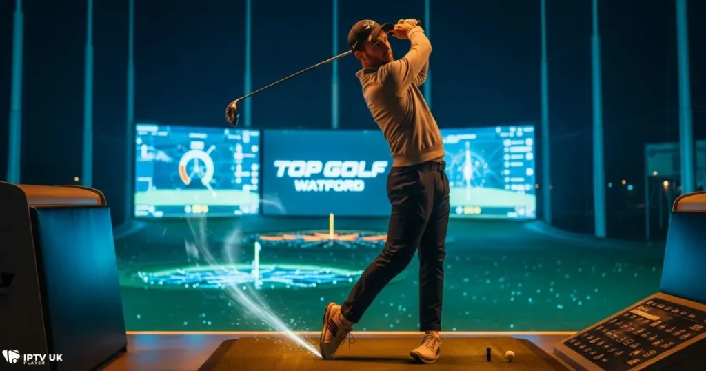 Golfer swinging at Top Golf Watford with modern digital screens in the background.